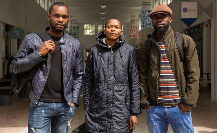 Three men posing for a photo