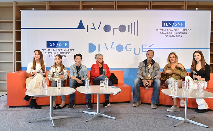 Anna Kynthia Bousdoukou, four adult and two children speakers sitting on couches at the SNF Dialogues event.