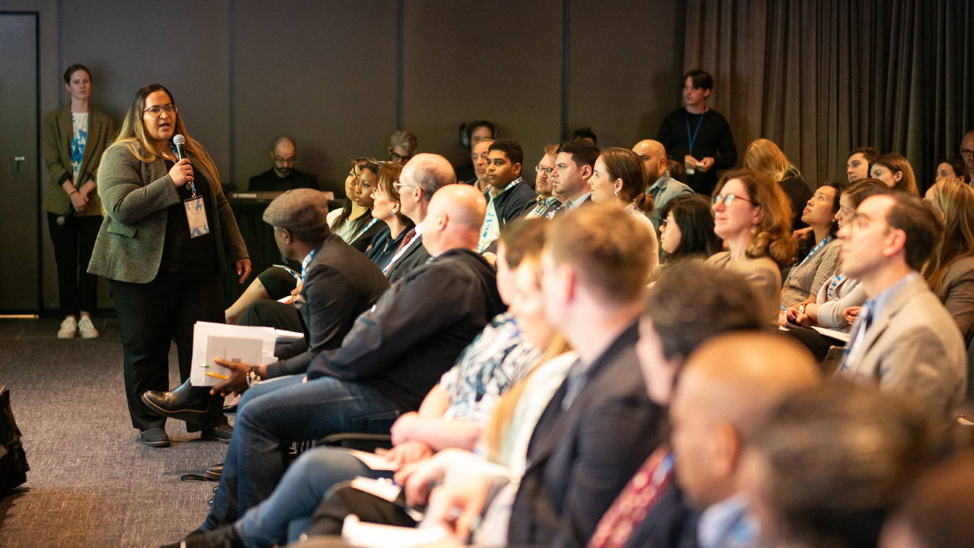 Woman speaking to the audience at the SNF Dialogues event held at the SNFL in NY.