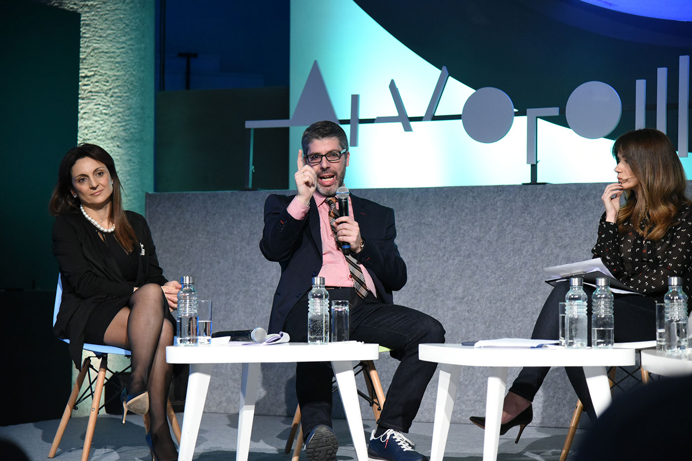 Three guests on stage at the SNF Dialogues event