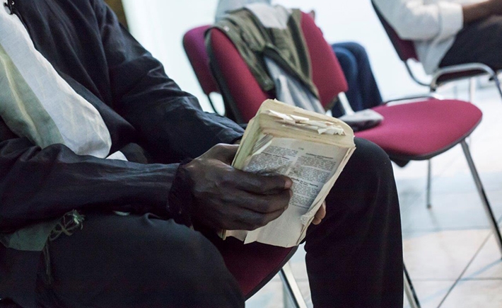 The hands of a man holding a book