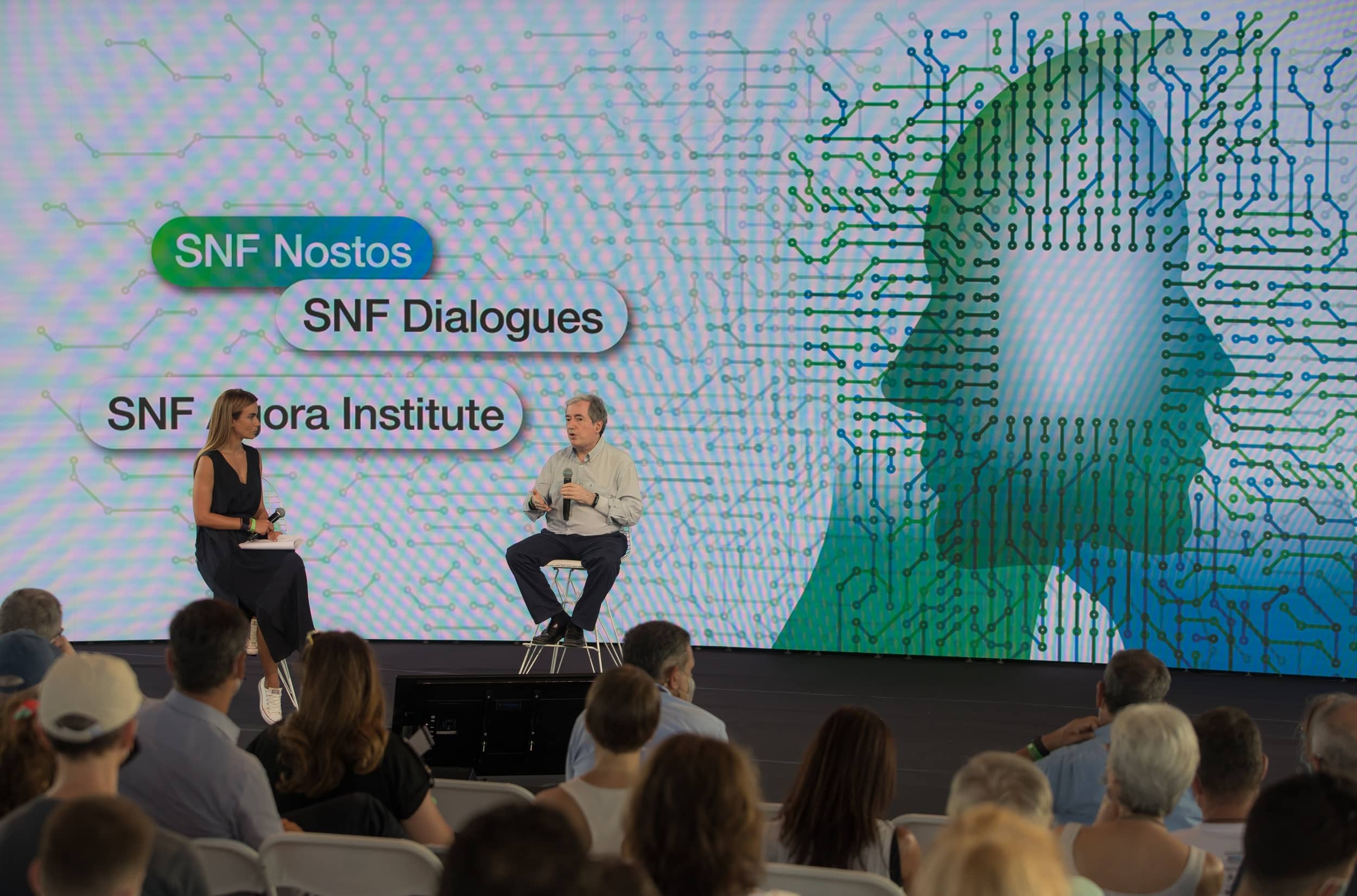 Anna Kynthia Bousdoukou and a guest speaker on stage at the SNF Dialogues event.