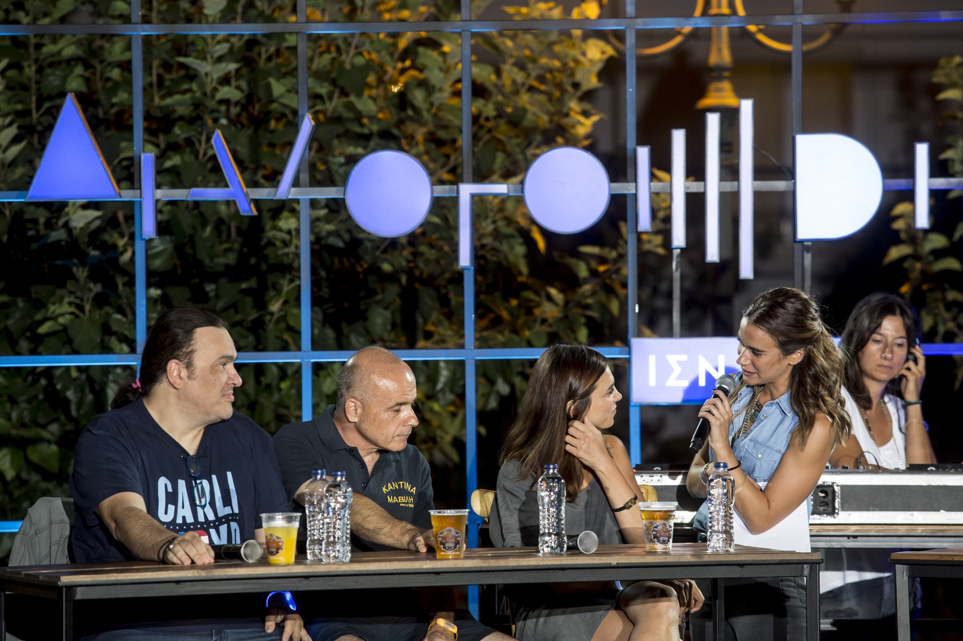 Anna Kynthia Bousdoukou speaking to three guest speakers at the SNF Dialogues event.