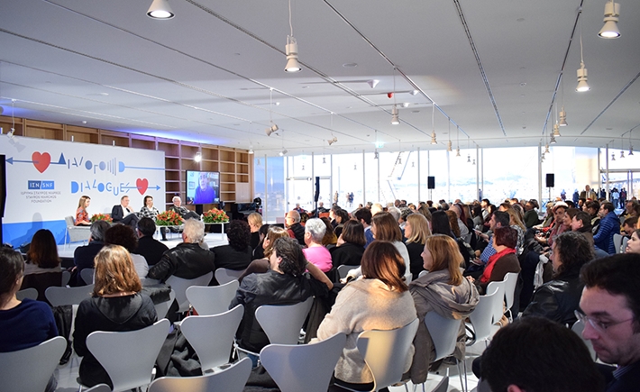 Audience from the side with speakers in the background at the SNF Dialogues event.