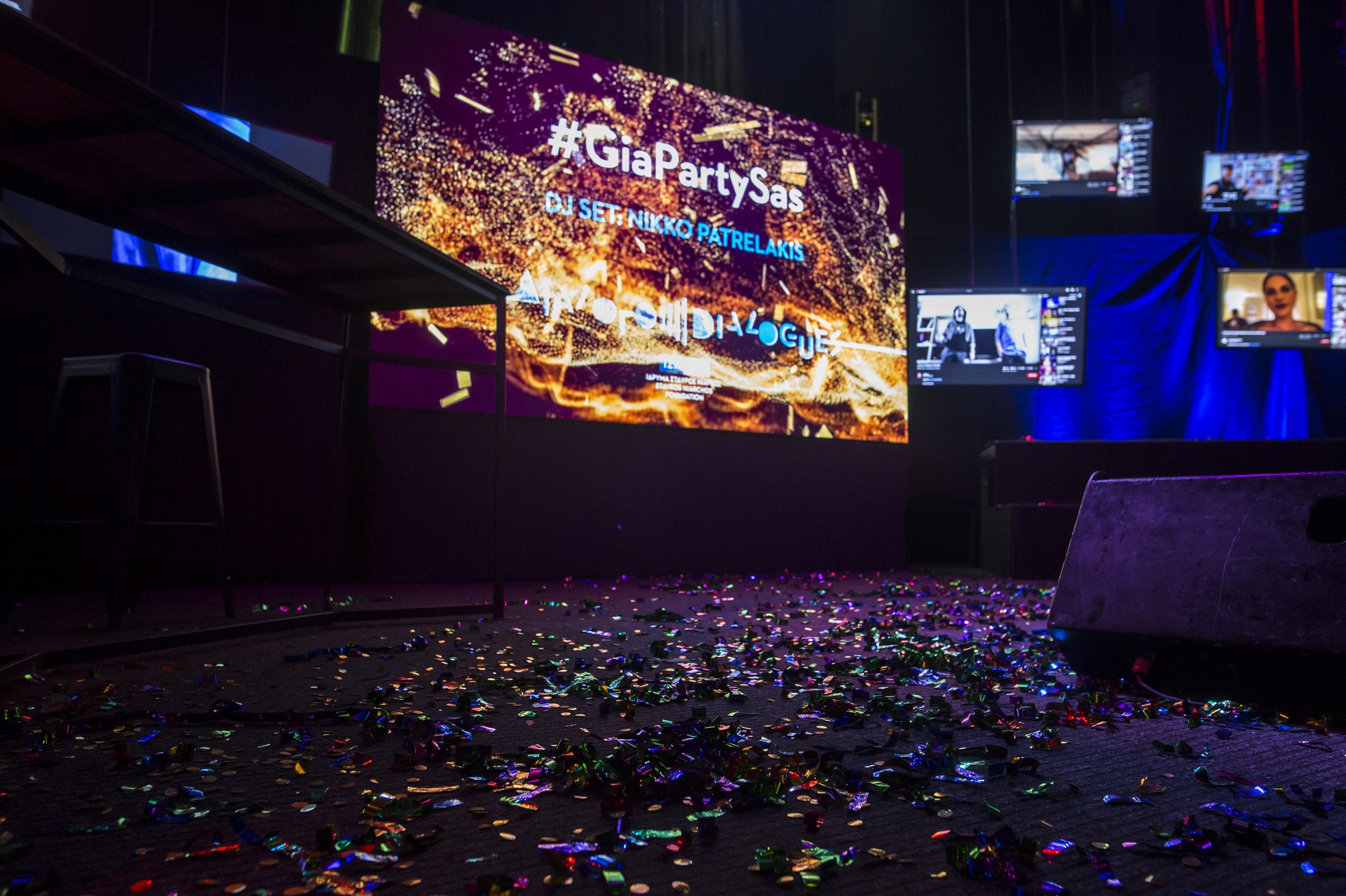 Σκηνή με κομφετί και οθόνη με πολύχρωμα γραφικά.