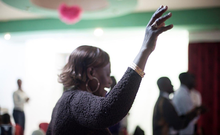 A woman raising her hand while making a speech