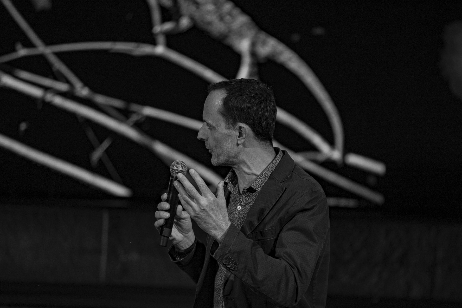 Man speaker holding the mic at the SNF Dialogues.