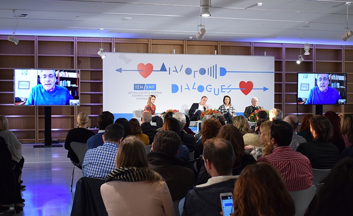 Audience from the back with speakers in the background at the SNF Dialogues event.