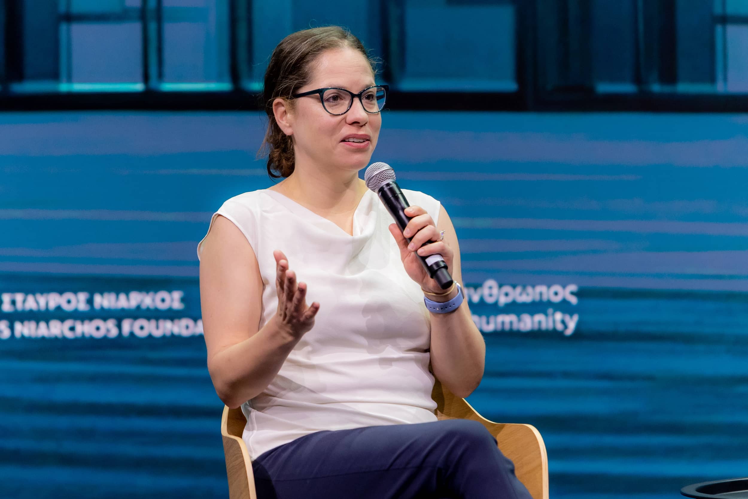 Woman speaker holding the mic at the SNF Dialogues event.