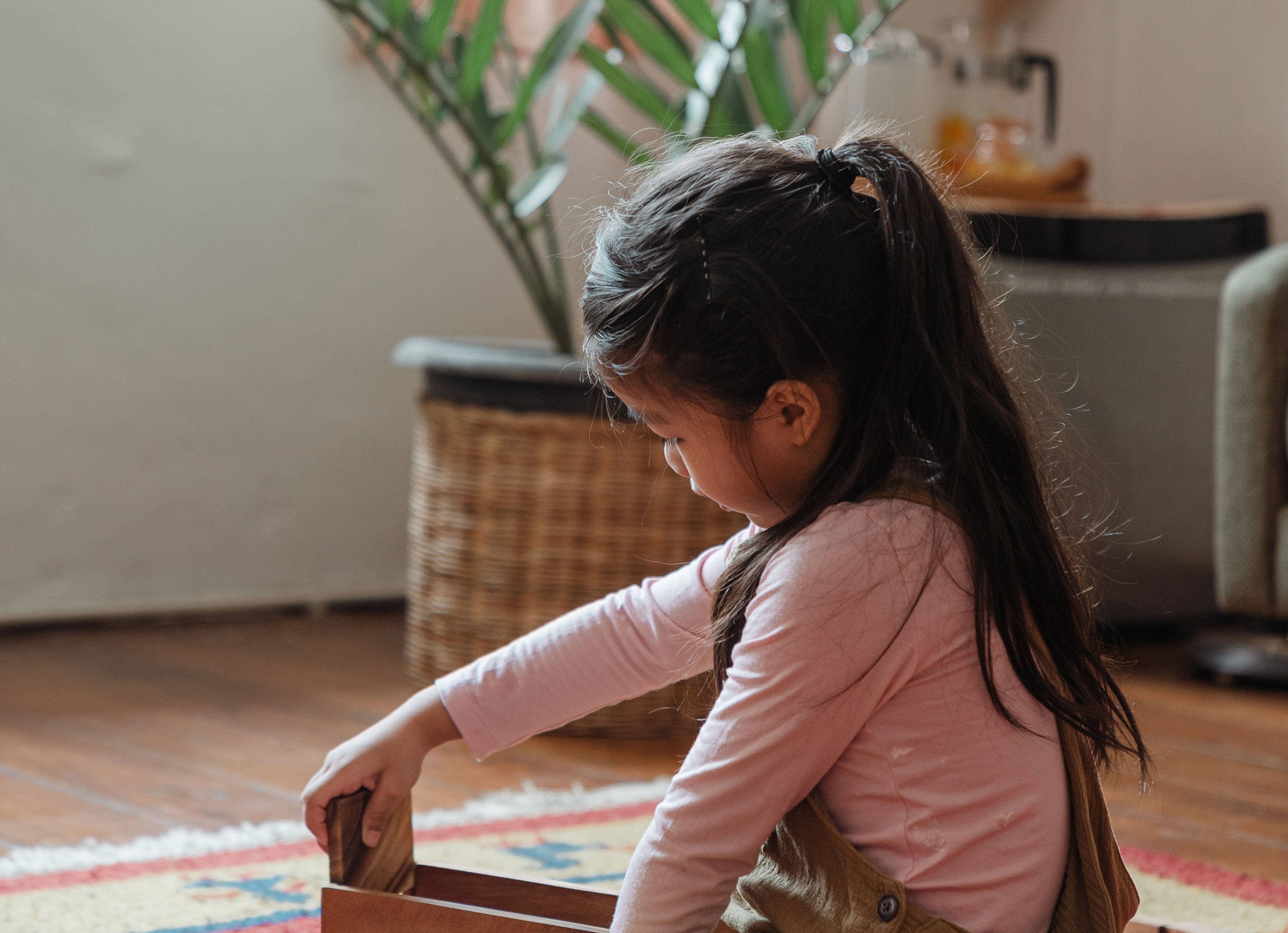 A young child playing with a wooden toy