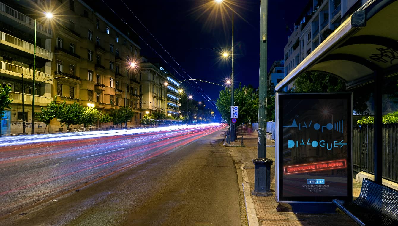 Banner depicting a city at night and a bus stop sign located on the roadside saying 