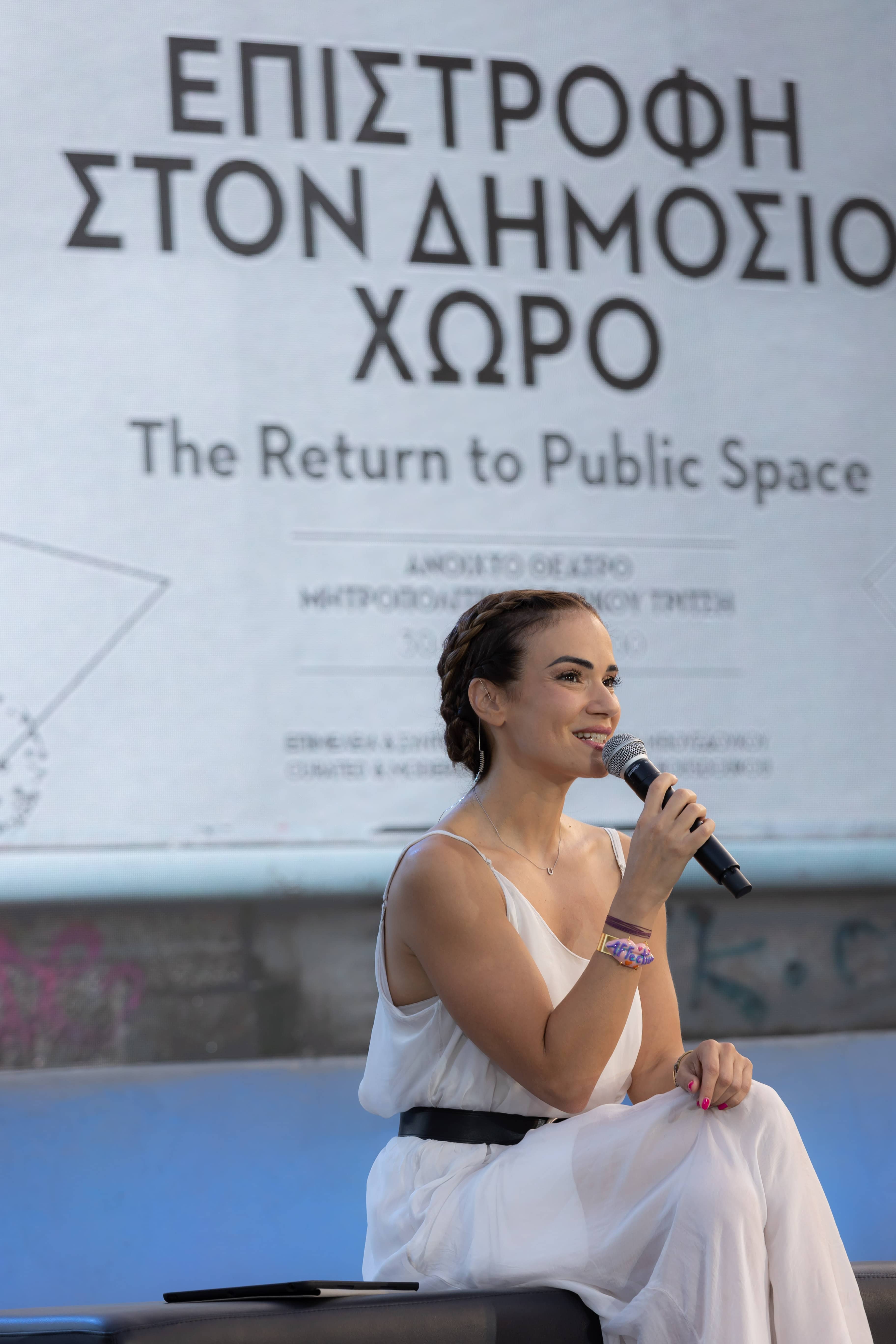 Anna Kynthia Bousdoukou holding the mic at the SNF Dialogues event.