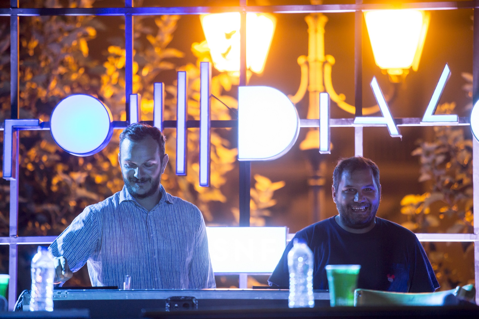 Two men standing on stage at the SNF Dialogues event.