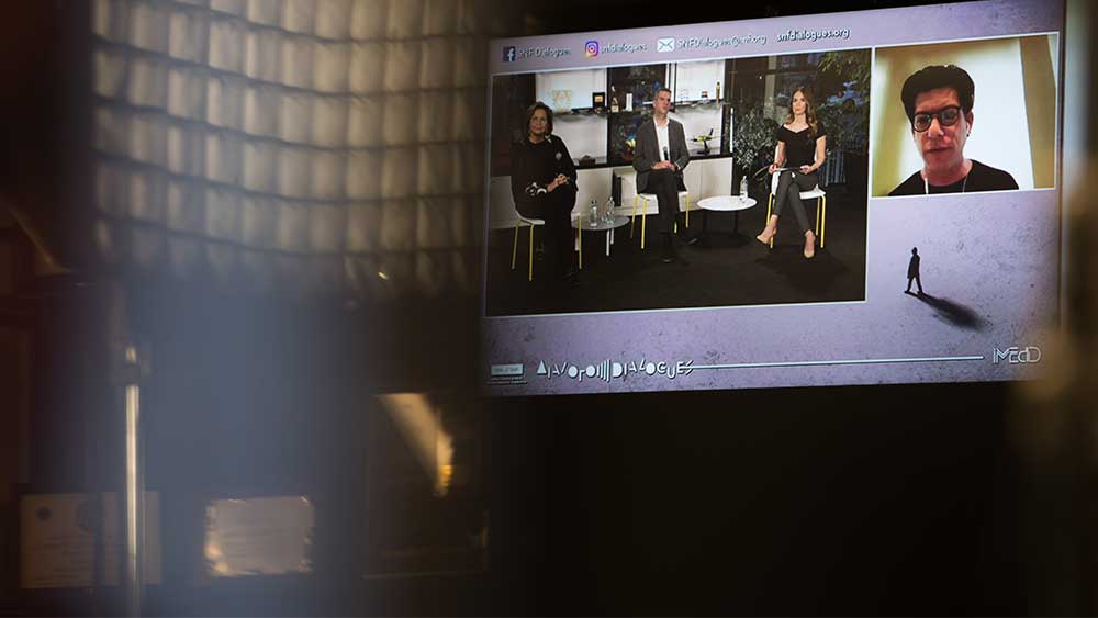 A screen showing the speakers at the SNF Dialogues event.