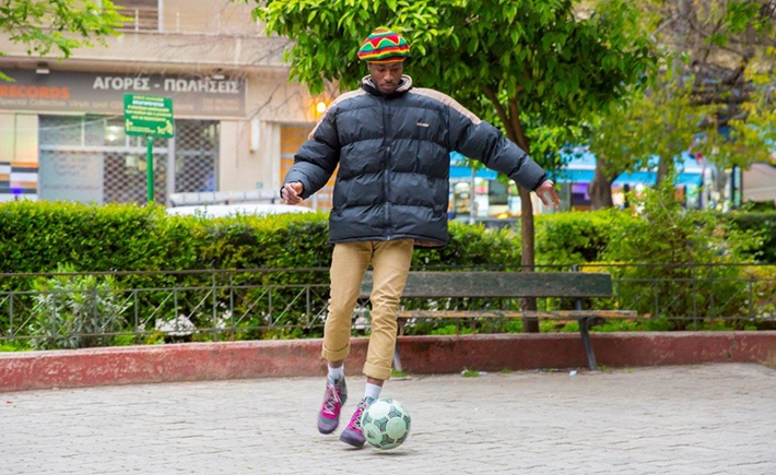 A man playing with a soccer ball in a park