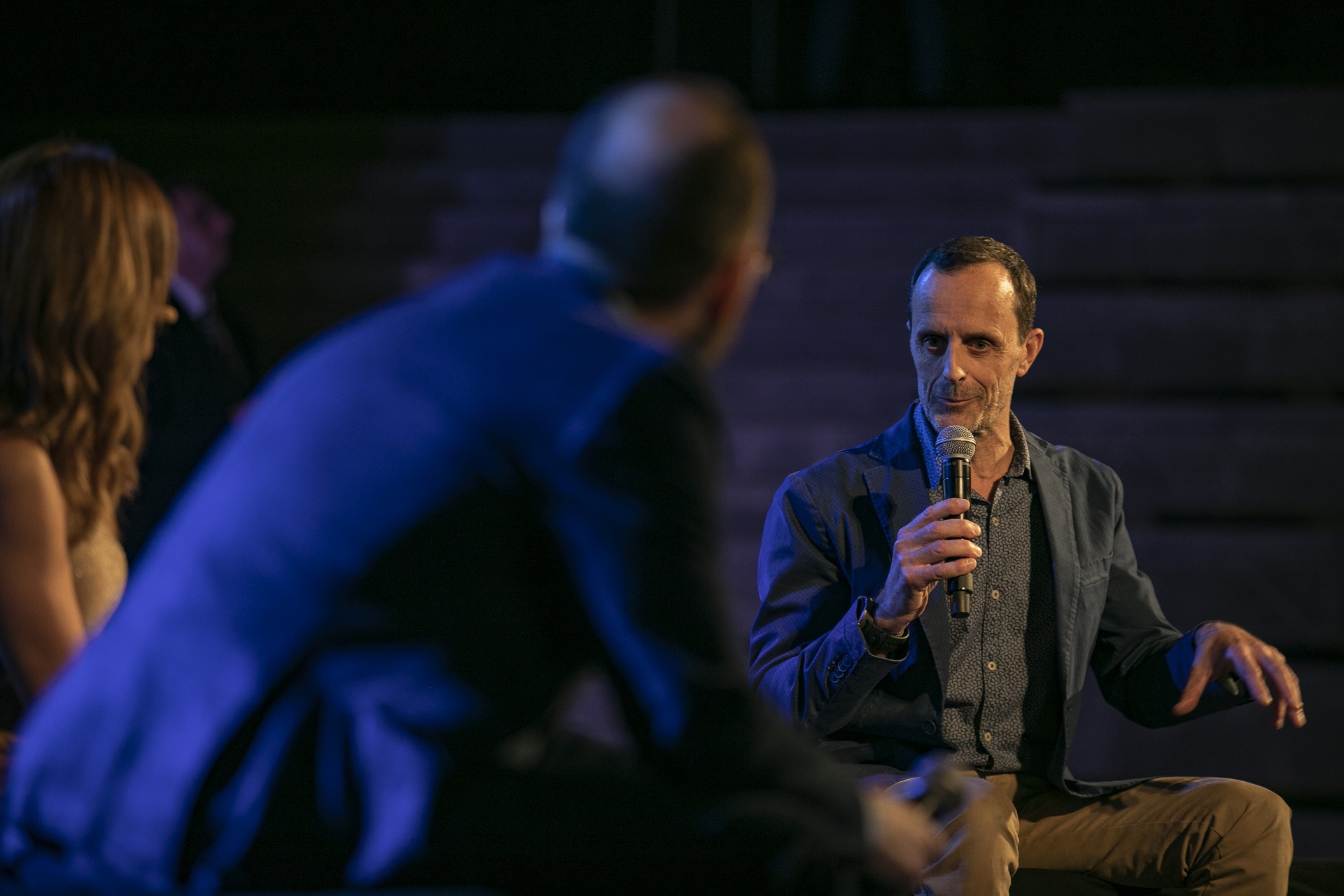 Man speaker holding the mic at the SNF Dialogues event.