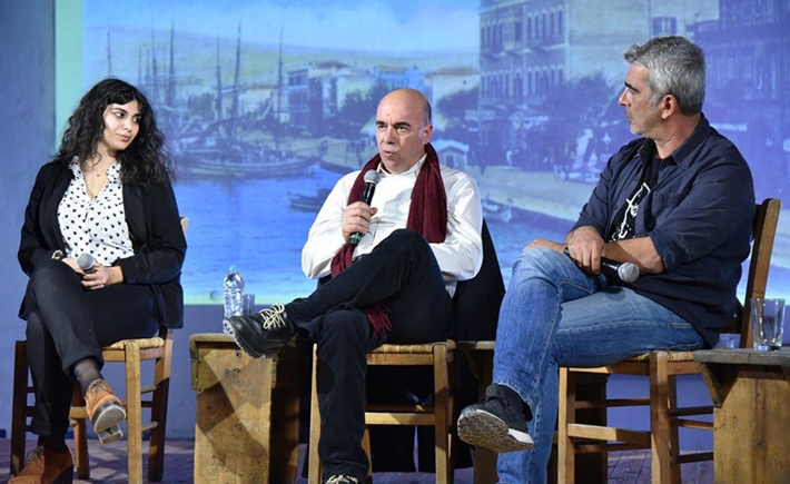 Three guest speakers on stage at the SNF Dialogues event