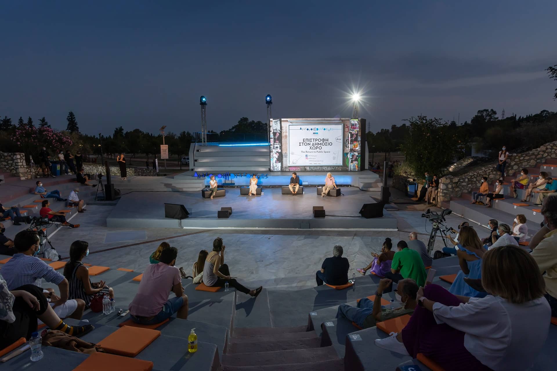 Audience at the SNF Dialogues looking at stage where there are four speakers.