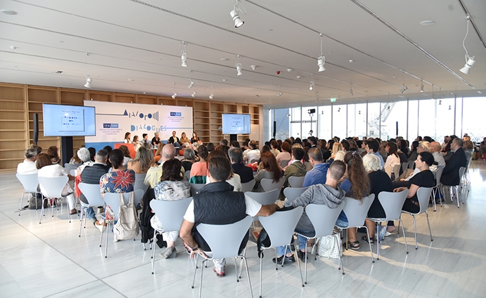 Audience at the SNF Dialogues looking at stage where there are seven speakers.